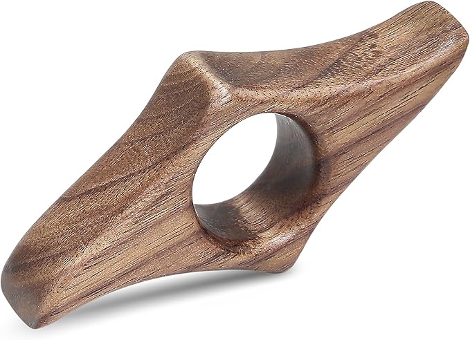 A wooden thumb ring page holder keeping a book open.